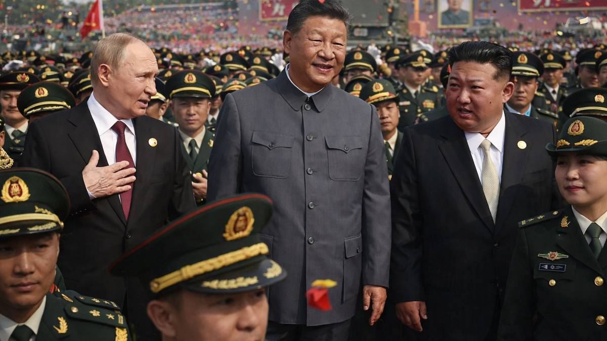 Russia's President Vladimir Putin walks with China's President Xi Jinping and North Korea's leader Kim Jong Un