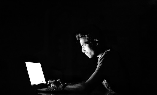 image of someone staring at a compter screen
